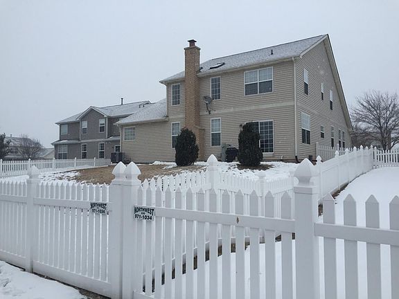 fenced back yard, sits on hill with cement patio