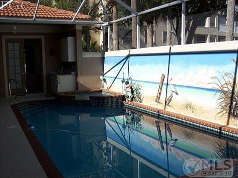 Custom Mural on Screen Lanai Pool Wall. Spa and Wet Bar in pool area.