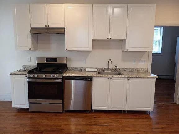 The all new kitchen contains has a stainless gas stove, range hood, dishwasher and Subzero refrigerator.