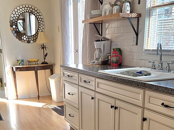 Kitchenette, has a electric oven, double sink, coffee maker, microwave, no dishwasher, back private deck, dishes, pots and pans, bakeware, plates and cups.