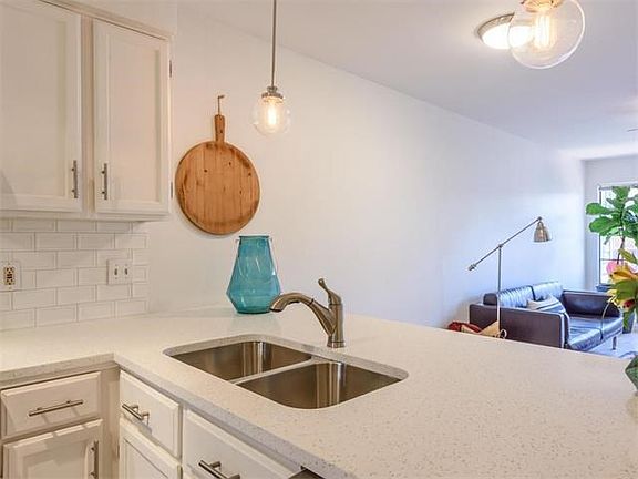 Sleek quartz counters create the perfect kitchen island large enough for 3-4 barstools.