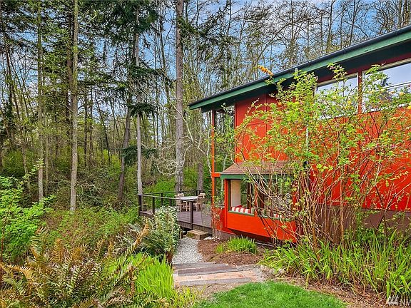 Looking south from the brick patio to the woods behind the home and the generous deck. Decking is composite for long life.