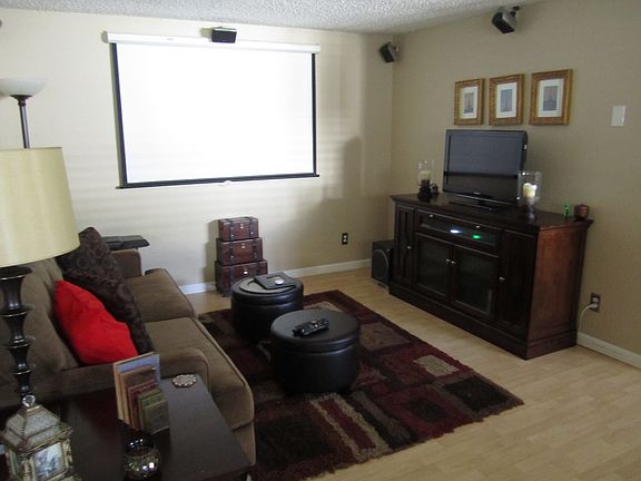 Living Room with theater pulled down screen and surround so