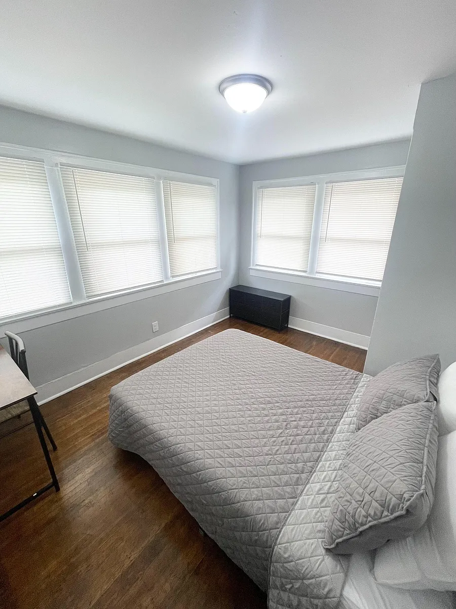 Bedroom with hardwood floors, ample windows with blinds, and space for a full/queen bed plus a small work area. - N Gladstone Ave