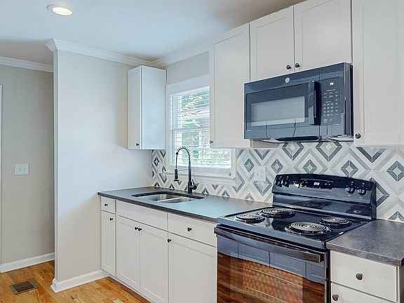 Washer/dryer hook-ups in the back of the kitchen.