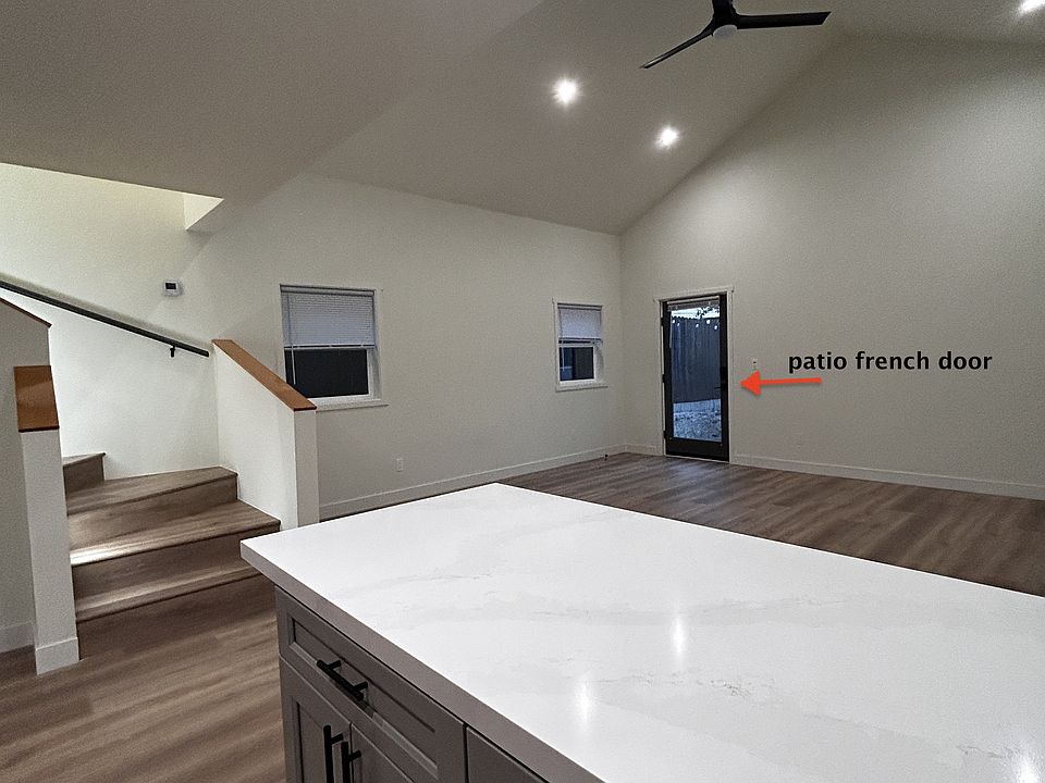 kitchen island looking into open floor plan. stairs leading to 2nd floor