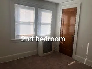 2nd large carpeted bedroom with closet.