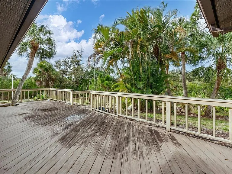 Deck off lanai with steps to back yard toward creek water frontage