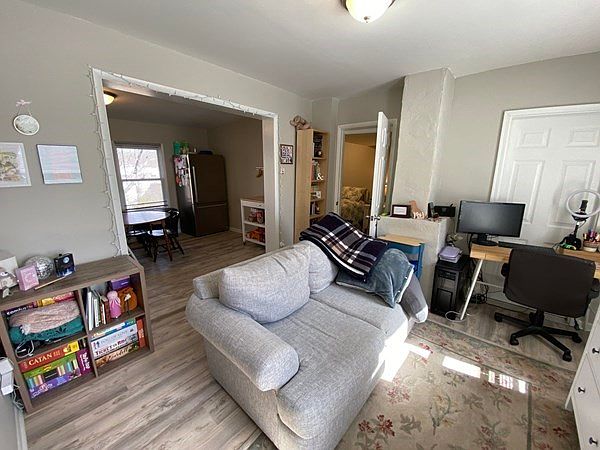 Living room, kitchen and open door to bedroom