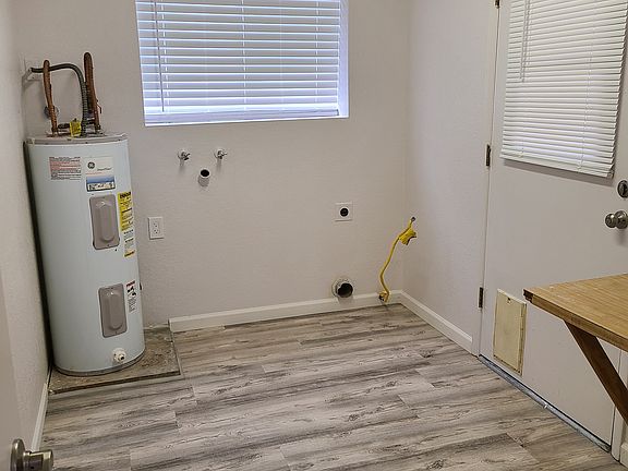 Laundry room off of kitchen, door leads to back covered patio and backyard