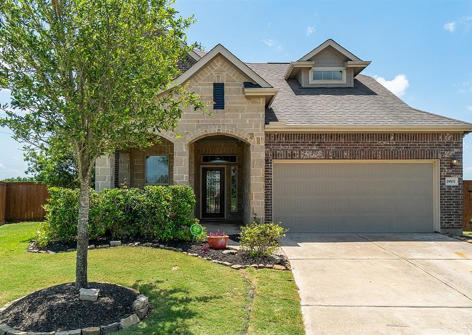 Charming brick and stone exterior offers great curb appeal to this Chesmar home located on over a 1/2 acre lot in the master-planned community of Towne Lake.