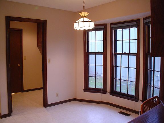 Breakfast nook in kitchen with adjacent laundry room