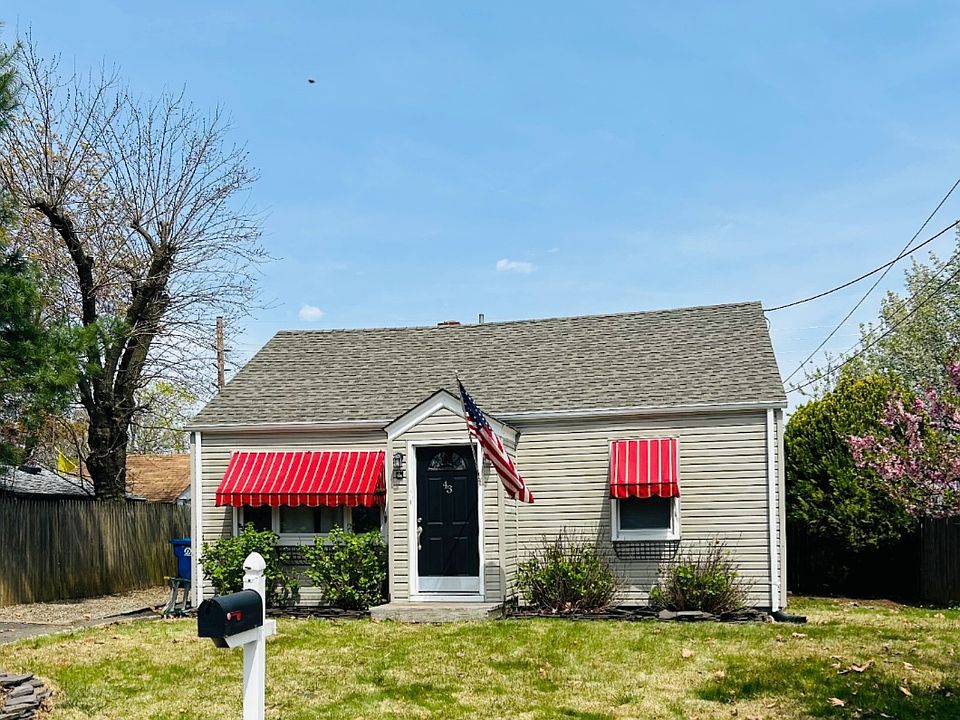 Charming 2 bedroom home. Beautiful hydrangeas complimenting custom awnings.