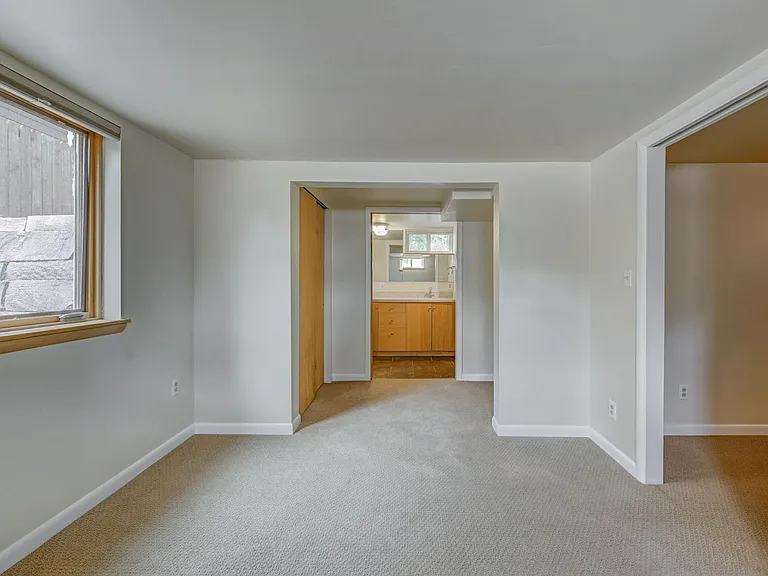 Downstairs master bedroom with view to walk-in closets and bathroom
