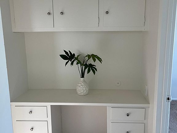 Extra work and desk area with storage.