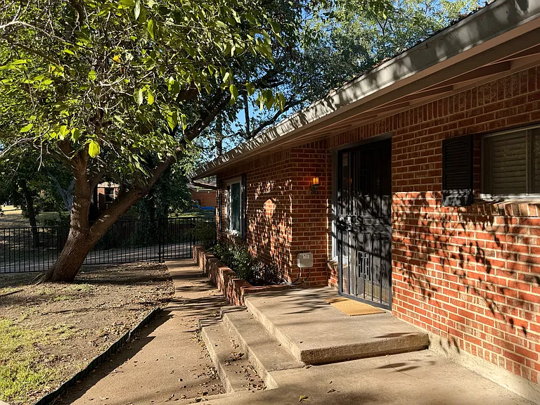 Front door and fenced front yard