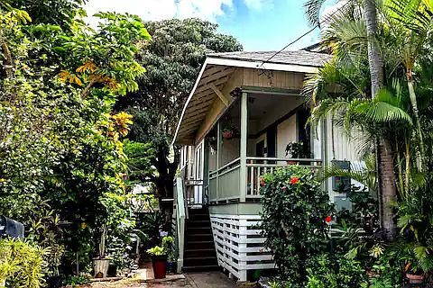 This is the font of the home with stairs going up to the porch where you can relax on the couch or dine at the table.
Your one stall parking is located at the foot of the stairs.