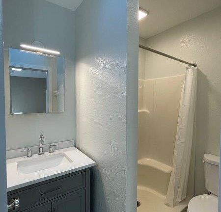 Large shower, with brand new medicine cabinet, vanity unit, and flooring.