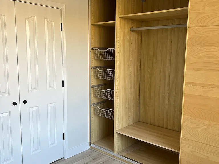 Wardrobe spans entire wall.