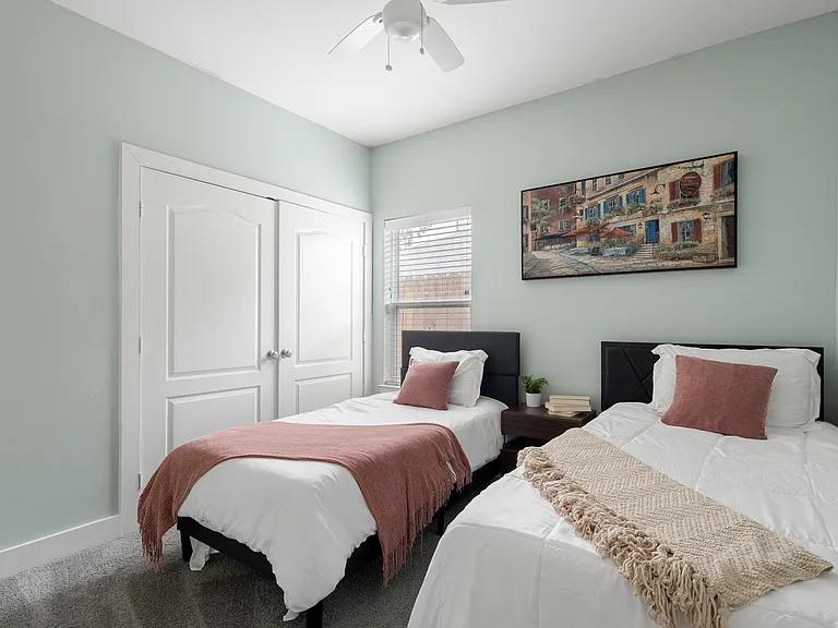 Bedroom 1: Furnished private bedroom _ $900/month, shares hallway bathroom.