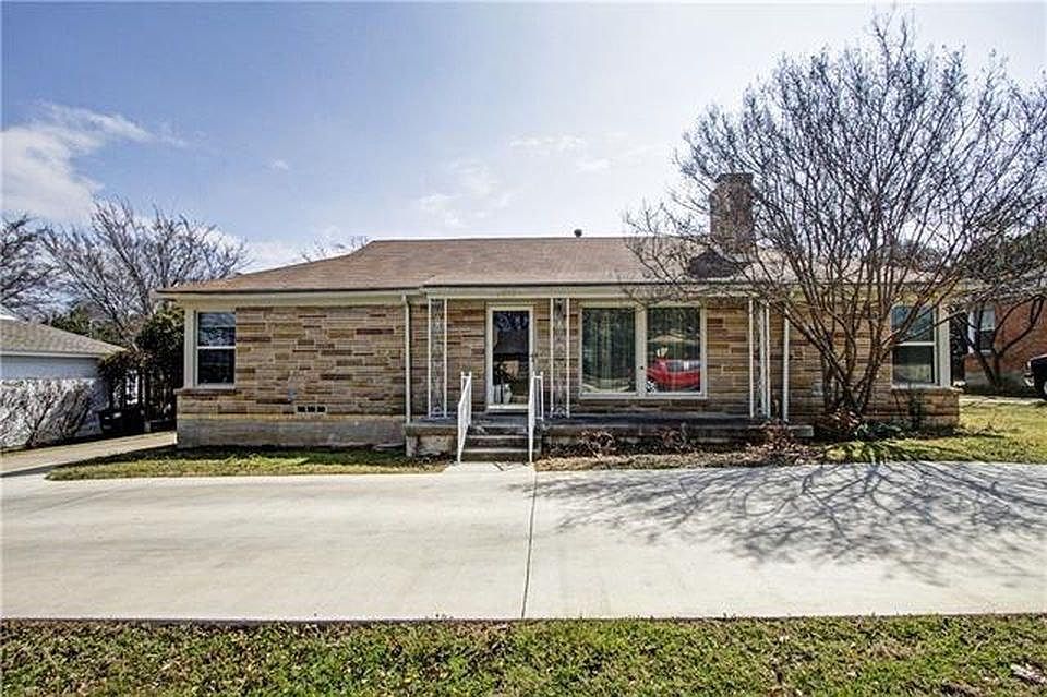Circle Driveway in front of house. Storm door on front door.