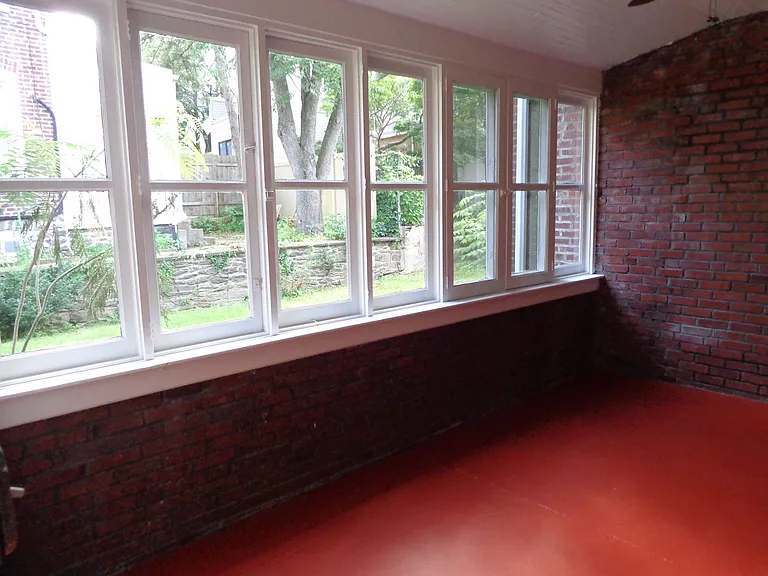 Enclosed porch/entry with windows to the side yard