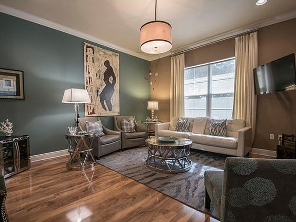 Fabulous Great Room with wood laminate flooring, crown molding, recessed lighting and chandelier