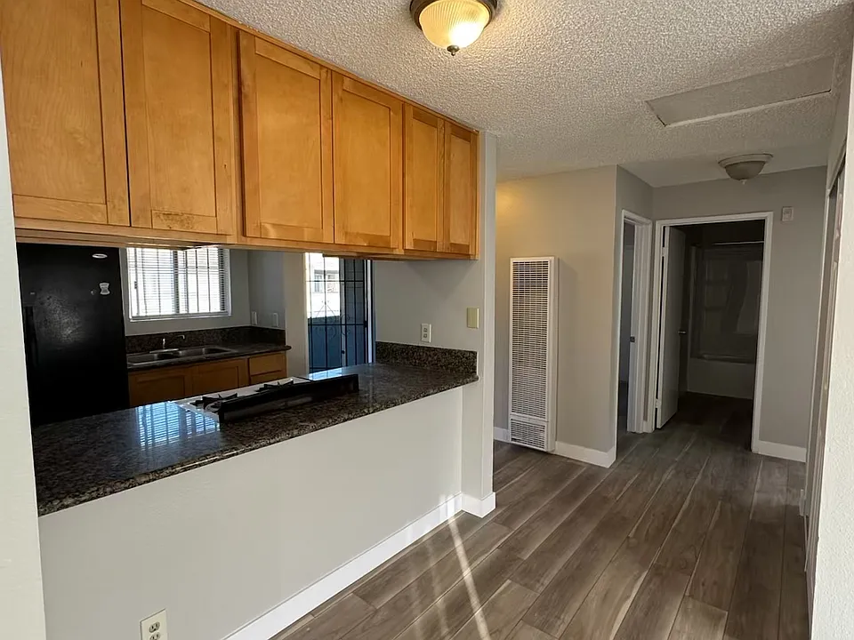 View of kitchen with new plank flooring and new paint