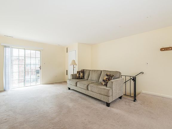 Spacious and sun filled living room with sliders to the balc