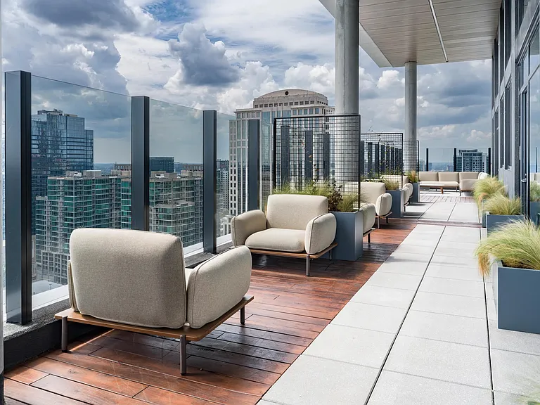 A rooftop terrace with comfortable seating and sweeping Atlanta skyline views creates a relaxed setting to gather above the city.