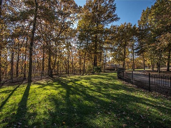 The fenced area protects pets and kids.   Trees surround the property.