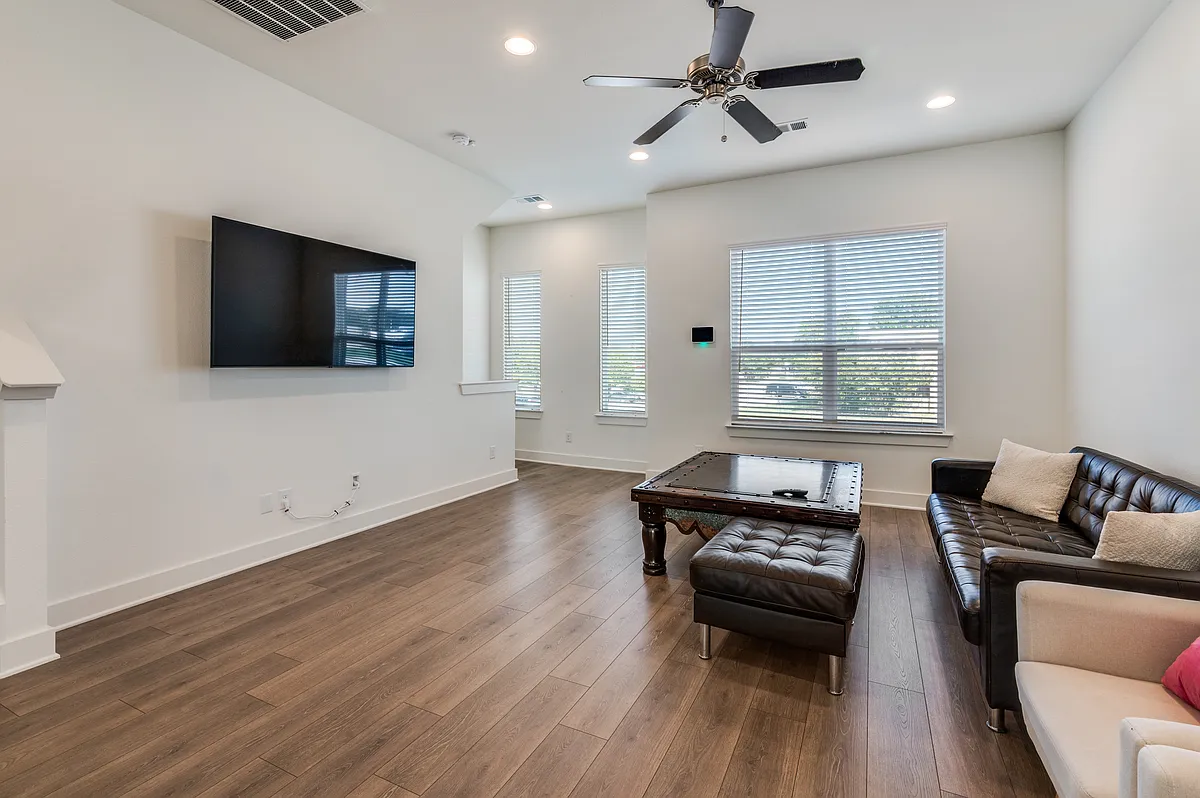 Living room (comes unfurnished) with ceiling fan and lots of natural light - 2802 Addison Park Ln