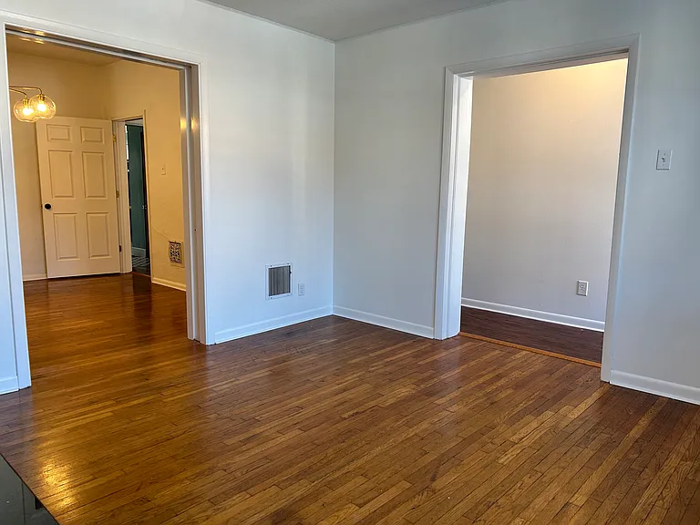 Standing in living room looking at dining room (through left cased opening) and main hallway (through right cased opening)