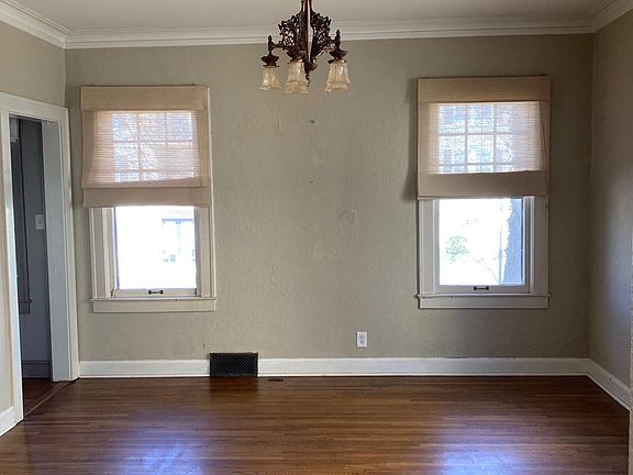 The dining room is light and bright with four windows.