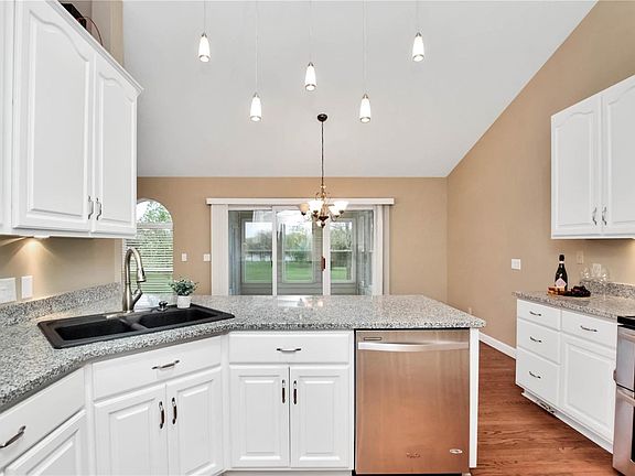 Kitchen is adjacent to breakfast area that opens to 3 seasons room
