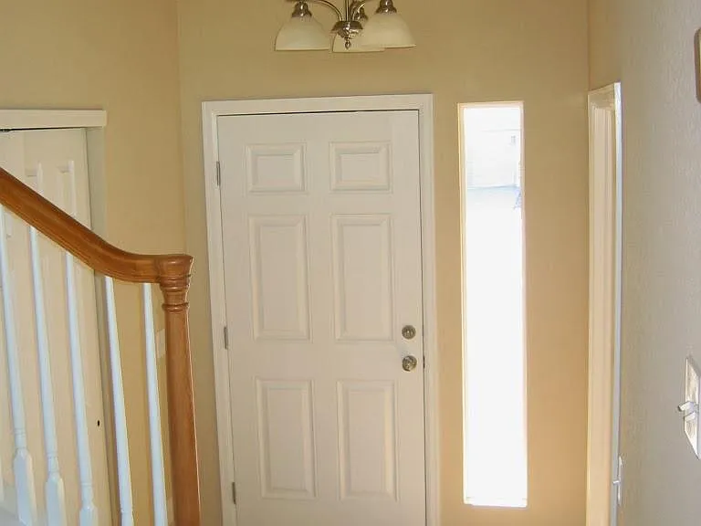 Entry foyer, staircase to the second floor at left.