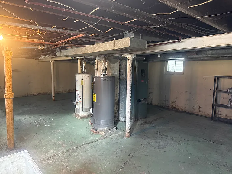 Clean, spacious basement with ample storage, dedicated laundry hookups, and separate utility area with hookups. Perfect for extra storage and keeping seasonal items organized.