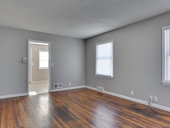 Living with lots of natural light and original hardwood floors.