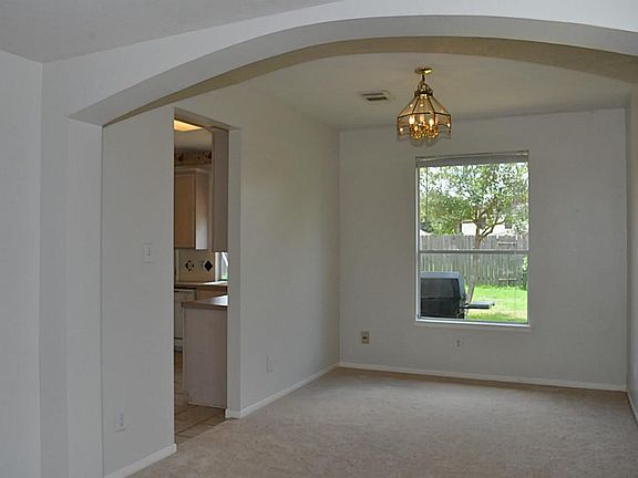 THE FORMAL DINING ROOM IS SET OFF FROM THE LIVING ROOM AND FEATURES 9-FOOT CEILING AND LARGE WINDOW WITH SCENARY TO THE BACK PATIO. THRU THE DOOR STEP INTO KITCHEN AREA AT THE BACK OF THE HOME,