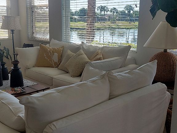 Living room with pond and golf course view