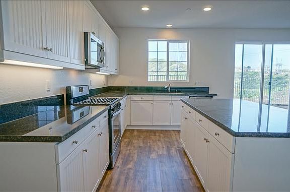 Kitchen with white cabinets and center island
