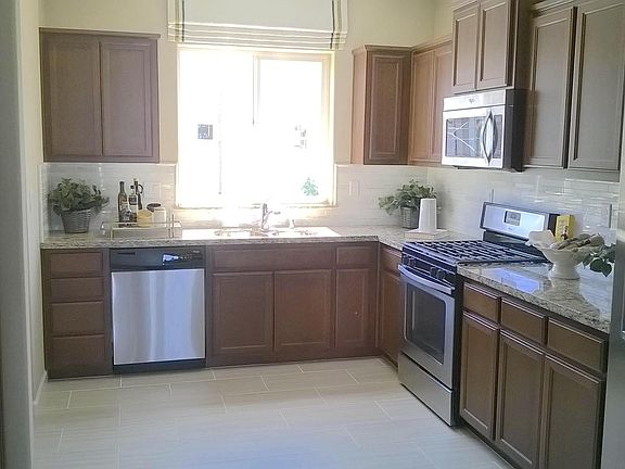 Bright & open concept kitchen with stainless steel appliances.