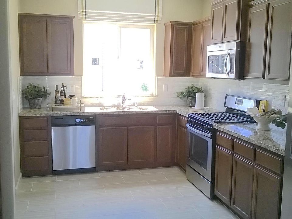 Bright & open concept kitchen with stainless steel appliances.
