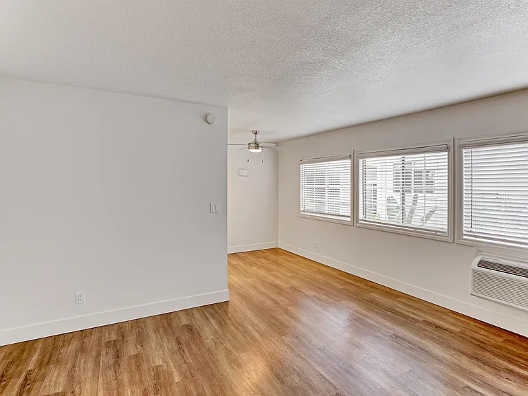 A room with wooden floors and white walls.