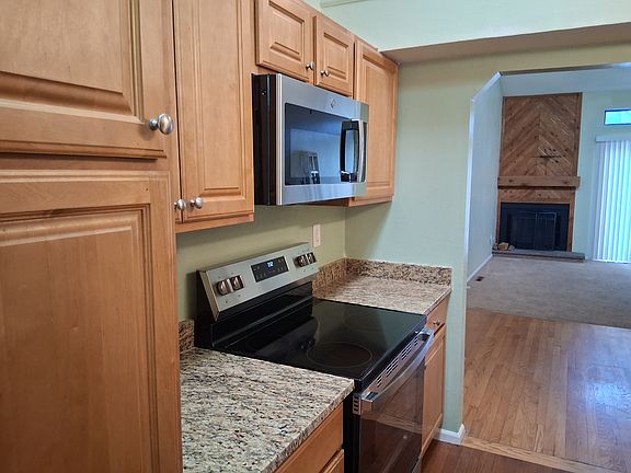 Kitchen close to dining area. Hardwood floor in dining aea