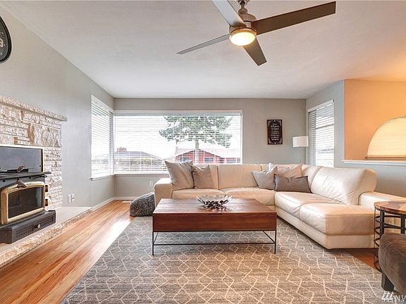 As you enter the home, you are welcomed by a light and bright living room with a picture window revealing city views.