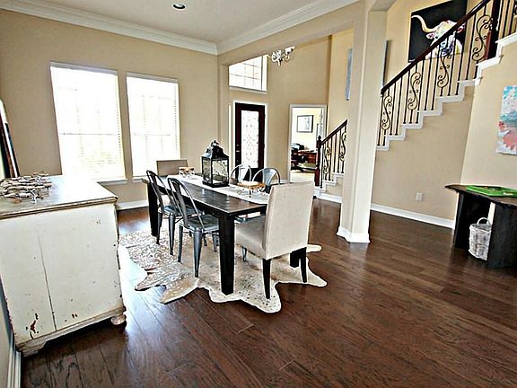 THIS DINING ROOM IS ACCENTED BY HARDWOOD FLOORS, CROWN MOLDING AND A GRAND COLUMN