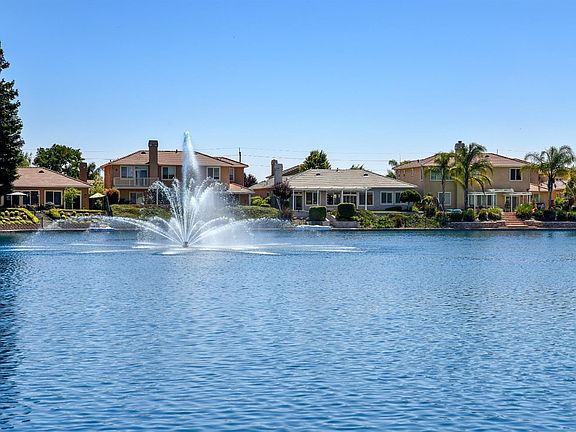 Sundance Lake Beauty!  The single story home to the right of the fountain has an amazing view of the lake. With 3 bedrooms, an office space plus a hobby room and 3-car garage all on one level, it's the perfect place to relax and enjoy life!