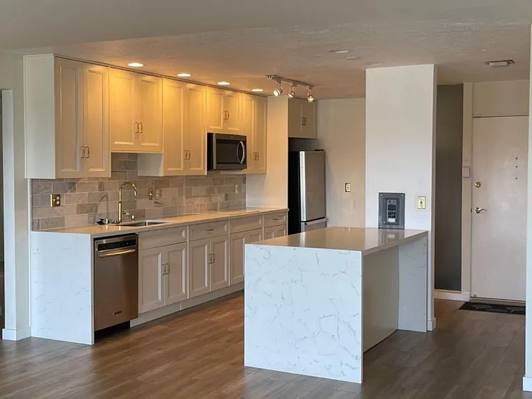 "Waterfall" style quartz-topped island