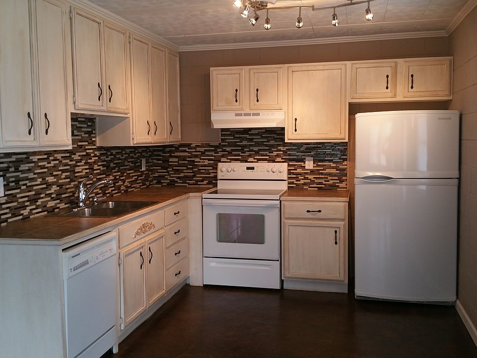 Kitchen with glass tile and custom cabinets